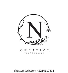 
N letter logo design with floral frame ornaments and circular leaves. the letter N design is beautiful and luxurious. N monogram typography. suitable for beauty, business, company, promotion logo etc