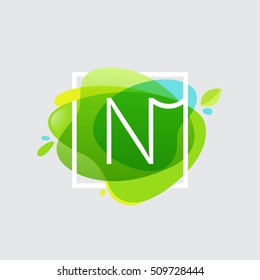 N letter logo in square frame at green watercolor splash background. Green art. Vector ecology typography for your posters, invitations, cards. 