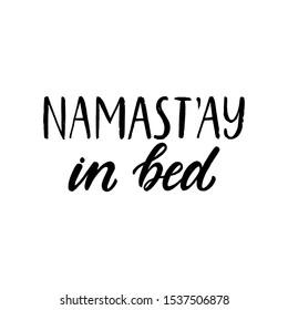 Namastay in bed. Hand written lettering quote. Cozy phrase for winter time. Modern calligraphy poster. Inspirational fall sign. Black and white.