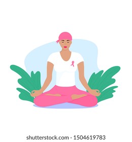 National Breast Cancer Awareness Month. Young woman with a scarf on her head and a pink ribbon on her chest is meditating.