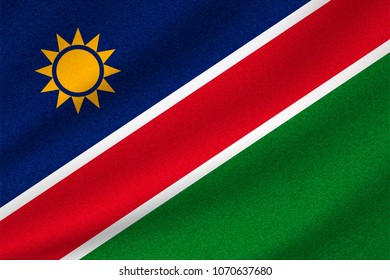 national flag of Namibia on wavy cotton fabric. Realistic vector illustration.
