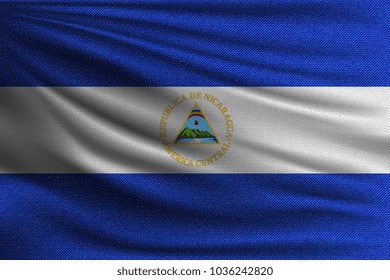 The national flag of Nicaragua. The symbol of the state on wavy cotton fabric. Realistic vector illustration.