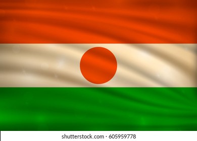 The national flag of Niger on wavy silk background with bokeh lights. Realistic vector illustration.