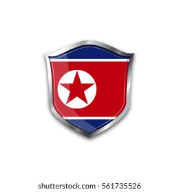 The national flag of North Korea. Metal shield with reflections on a white background.