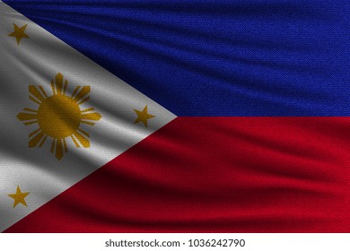 The national flag of Philippines. The symbol of the state on wavy cotton fabric. Realistic vector illustration.
