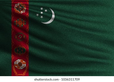The national flag of Turkmenistan. The symbol of the state on wavy cotton fabric. Realistic vector illustration.