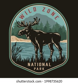 National park colorful logotype with grass moose standing on coast of river on forest and mountain landscape isolated vector illustration