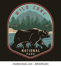 National park colorful vintage badge with bear walking on river coast on forest and mountain landscape isolated vector illustration