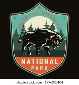 National park vintage colorful label with powerful bison on forest landscape isolated vector illustration