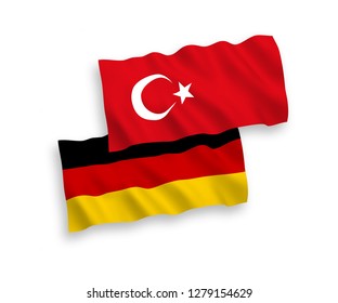 National vector fabric wave flags of Turkey and Germany isolated on white background.
