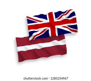 National vector fabric wave flags of Latvia and Great Britain isolated on white background.