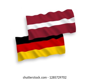 National Vector Fabric Wave Flags Of Germany And Latvia Isolated On White Background.