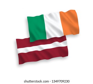 National vector fabric wave flags of Latvia and Ireland isolated on white background. 1 to 2 proportion.