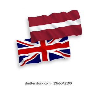 National vector fabric wave flags of Latvia and Great Britain isolated on white background. 1 to 2 proportion.