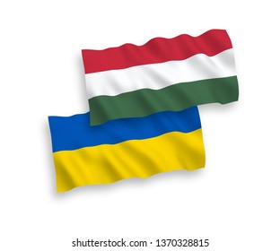 National vector fabric wave flags of Hungary and Ukraine isolated on white background. 1 to 2 proportion.