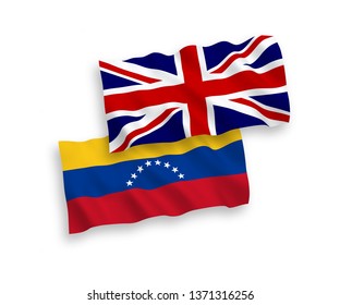 National vector fabric wave flags of Great Britain and Venezuela isolated on white background. 1 to 2 proportion.