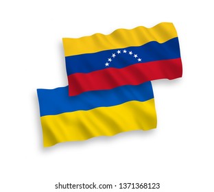 National vector fabric wave flags of Venezuela and Ukraine isolated on white background. 1 to 2 proportion.