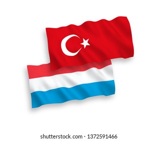 National vector fabric wave flags of Turkey and Luxembourg isolated on white background. 1 to 2 proportion.