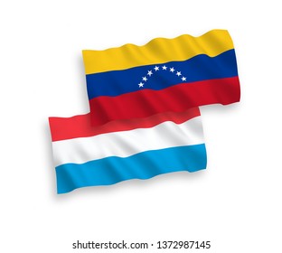 National vector fabric wave flags of Venezuela and Luxembourg isolated on white background. 1 to 2 proportion.