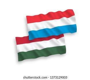 National vector fabric wave flags of Luxembourg and Hungary isolated on white background. 1 to 2 proportion.