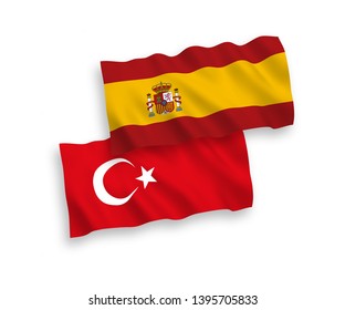 National vector fabric wave flags of Turkey and Spain isolated on white background. 1 to 2 proportion.