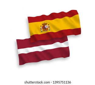 National vector fabric wave flags of Latvia and Spain isolated on white background. 1 to 2 proportion.