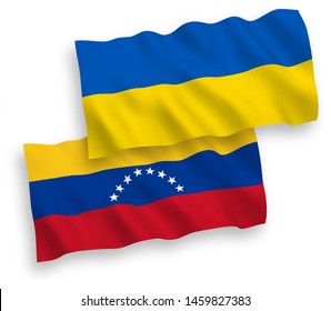 National vector fabric wave flags of Venezuela and Ukraine isolated on white background. 1 to 2 proportion.
