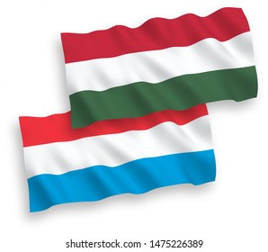 National vector fabric wave flags of Luxembourg and Hungary isolated on white background. 1 to 2 proportion.
