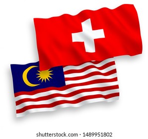 National vector fabric wave flags of Switzerland and Malaysia isolated on white background. 1 to 2 proportion.