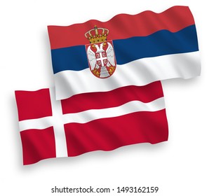 National vector fabric wave flags of Denmark and Serbia isolated on white background. 1 to 2 proportion.