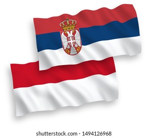National vector fabric wave flags of Indonesia and Serbia isolated on white background. 1 to 2 proportion.