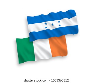National vector fabric wave flags of Ireland and Honduras isolated on white background. 1 to 2 proportion.