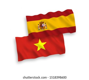 National vector fabric wave flags of Vietnam and Spain isolated on white background. 1 to 2 proportion.