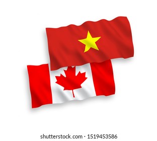 National vector fabric wave flags of Canada and Vietnam isolated on white background. 1 to 2 proportion.