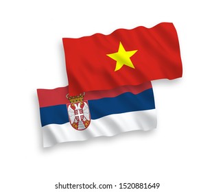 National vector fabric wave flags of Vietnam and Serbia isolated on white background. 1 to 2 proportion.