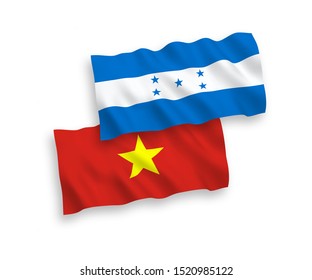 National vector fabric wave flags of Vietnam and Honduras isolated on white background. 1 to 2 proportion.