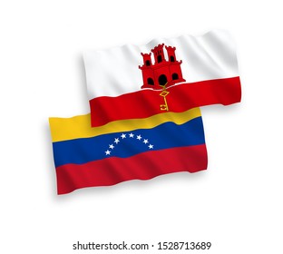 National vector fabric wave flags of Venezuela and Gibraltar isolated on white background. 1 to 2 proportion.