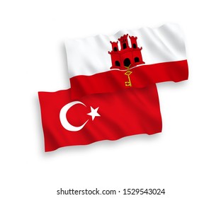 National vector fabric wave flags of Turkey and Gibraltar isolated on white background. 1 to 2 proportion.