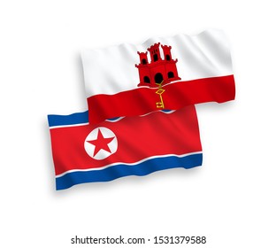 National vector fabric wave flags of North Korea and Gibraltar isolated on white background. 1 to 2 proportion.