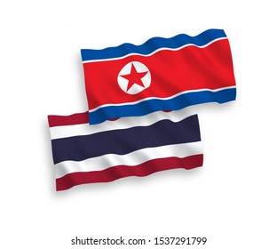 National vector fabric wave flags of North Korea and Thailand isolated on white background. 1 to 2 proportion.