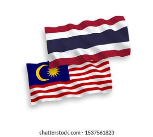 National vector fabric wave flags of Thailand and Malaysia isolated on white background. 1 to 2 proportion.