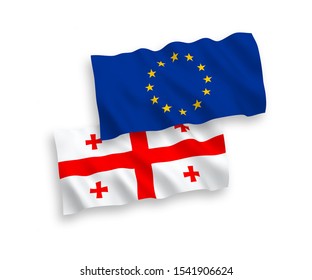 Banderas nacionales de la onda de la tela del Vector de la Unión Europea y de Georgia aisladas en el fondo blanco. Proporción 1 a 2.