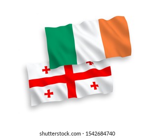 National vector fabric wave flags of Ireland and Georgia isolated on white background. 1 to 2 proportion.
