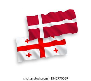 National vector fabric wave flags of Denmark and Georgia isolated on white background. 1 to 2 proportion.