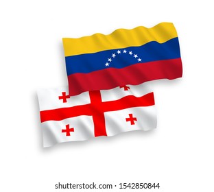 National vector fabric wave flags of Venezuela and Georgia isolated on white background. 1 to 2 proportion.