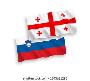 National vector fabric wave flags of Slovenia and Georgia isolated on white background. 1 to 2 proportion.