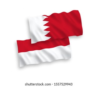 National vector fabric wave flags of Indonesia and Bahrain isolated on white background. 1 to 2 proportion.
