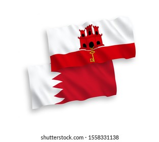 National vector fabric wave flags of Bahrain and Gibraltar isolated on white background. 1 to 2 proportion.