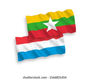 National vector fabric wave flags of Myanmar and Luxembourg isolated on white background. 1 to 2 proportion.