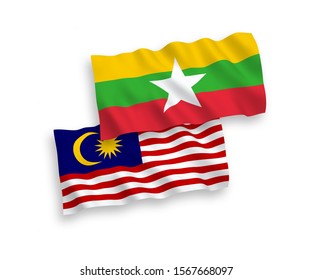 National vector fabric wave flags of Myanmar and Malaysia isolated on white background. 1 to 2 proportion.